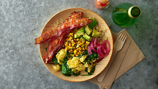 Hormel Bacon 1 Avocado Brunch Bowl with full slice bacon, eggs, pickled onions and greens.