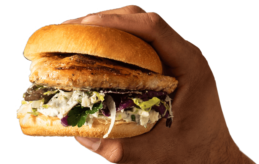 a hand holding a grilled chicken sandwich