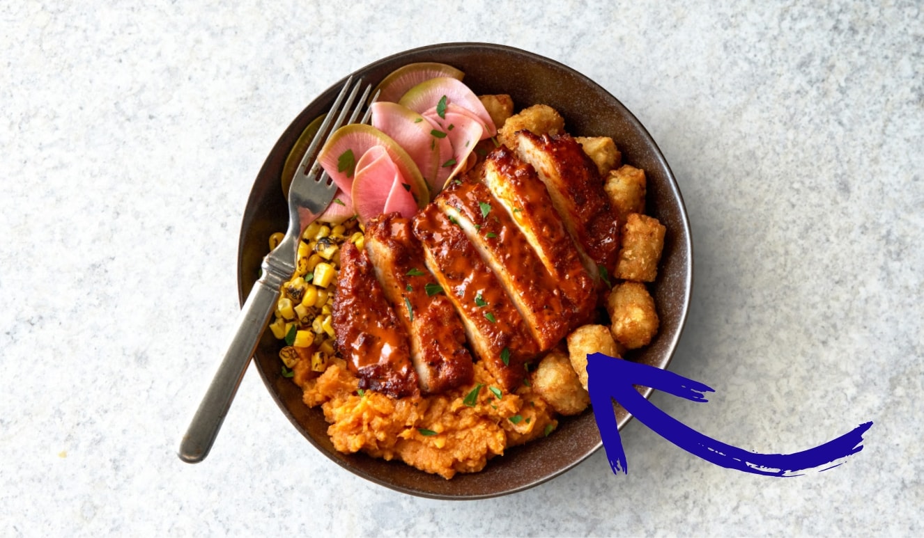 bowl with sliced battered chicken and tater tots