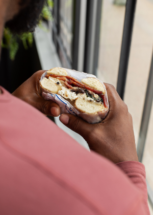 Over the shoulder shot of someone holding a breakfast sandwich