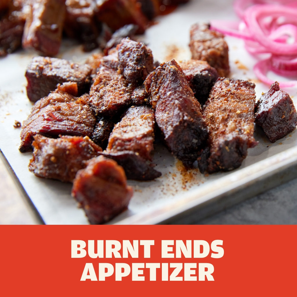 Austin Blues Burnt Ends served as an appetizer on a white plate with a sprinkle of barbecue seasoning and picked red onions.
