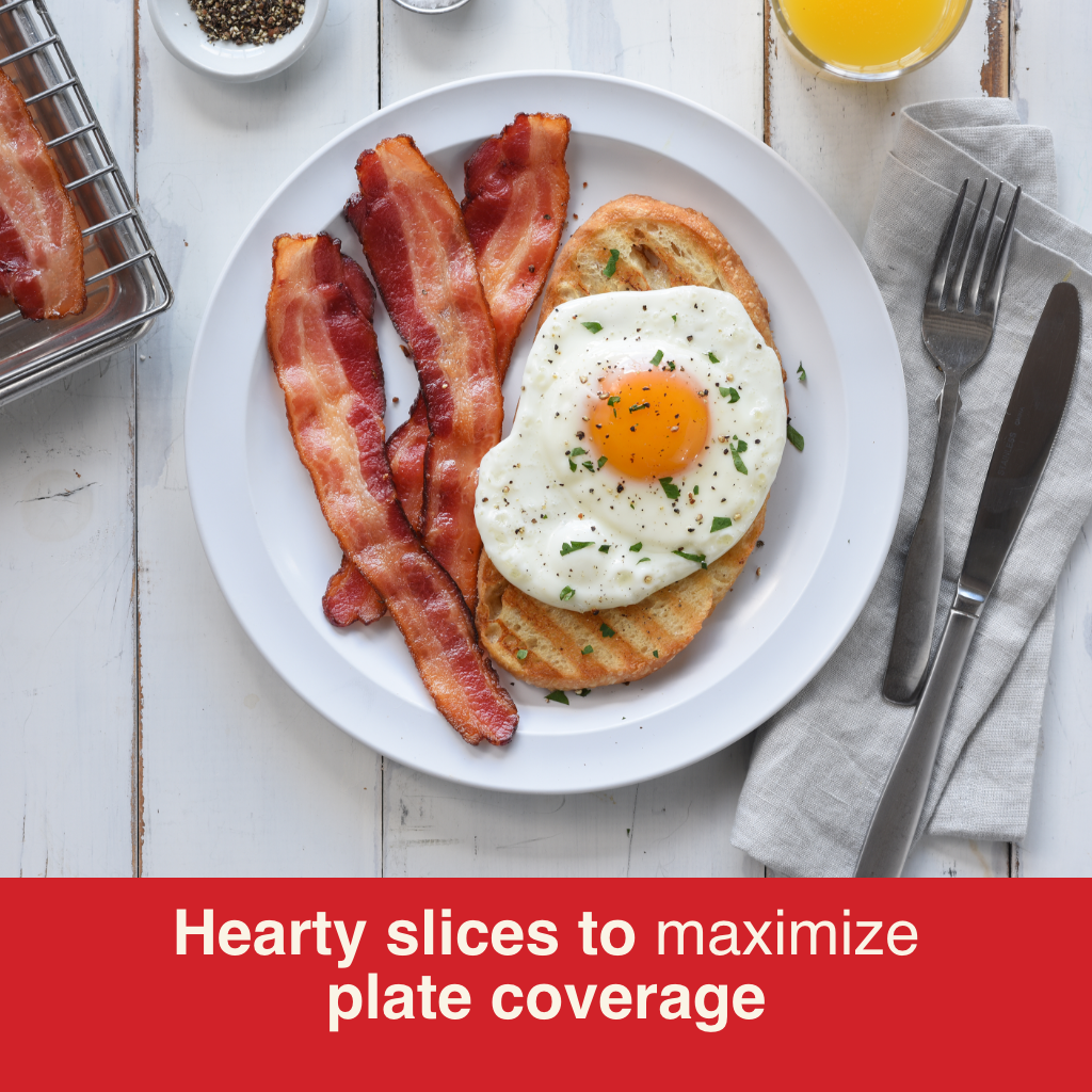Three slices of Hormel Bacon 1 served next to a buttery grilled slice of toast topped with a perfect sunny side up egg garnished with chopped parsley. All nicely plated on a white plate with orange juice, fork, knife and napkin on a white wood table.