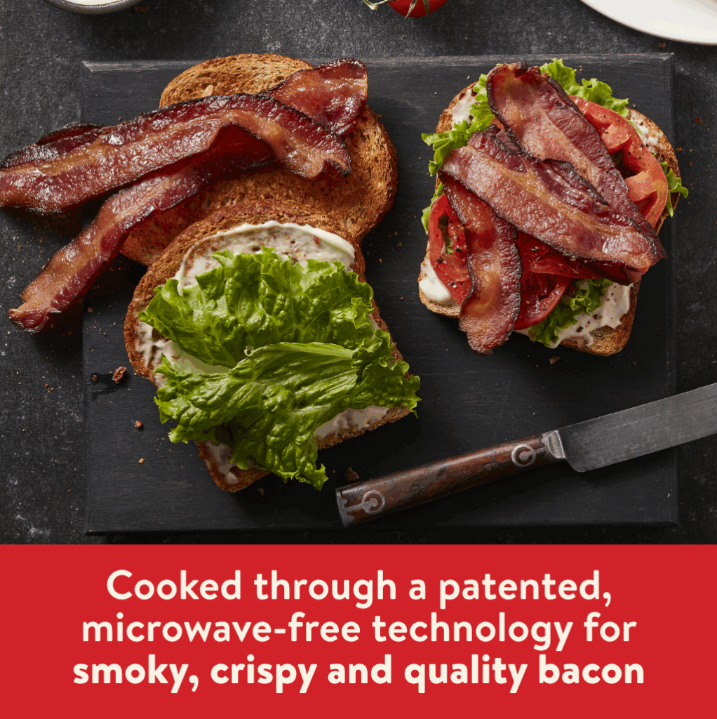 Hormel Bacon 1 on three slices of toast with mayo, lettuce and tomato on a black cutting board. There is a red bar at the bottom of the image with white text that reads