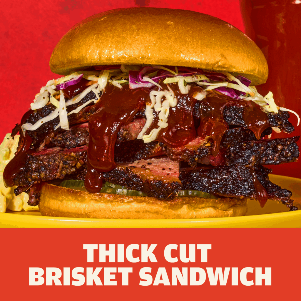 Austin Blues Texas Prime Brisket sandwich on a brioche bun topped with coleslaw