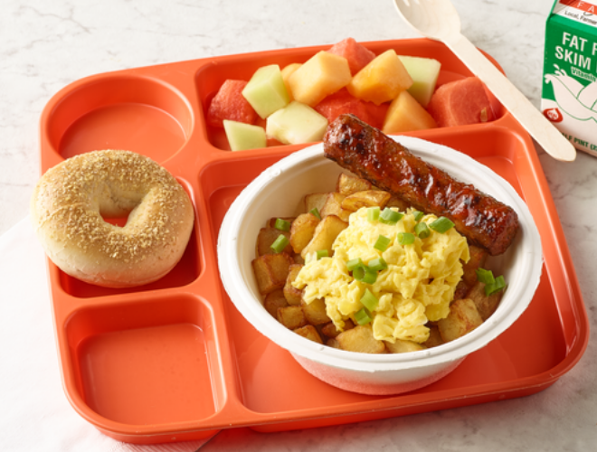 spicy turkey sausage potato breakfast bowl with a side of fruit and bagel